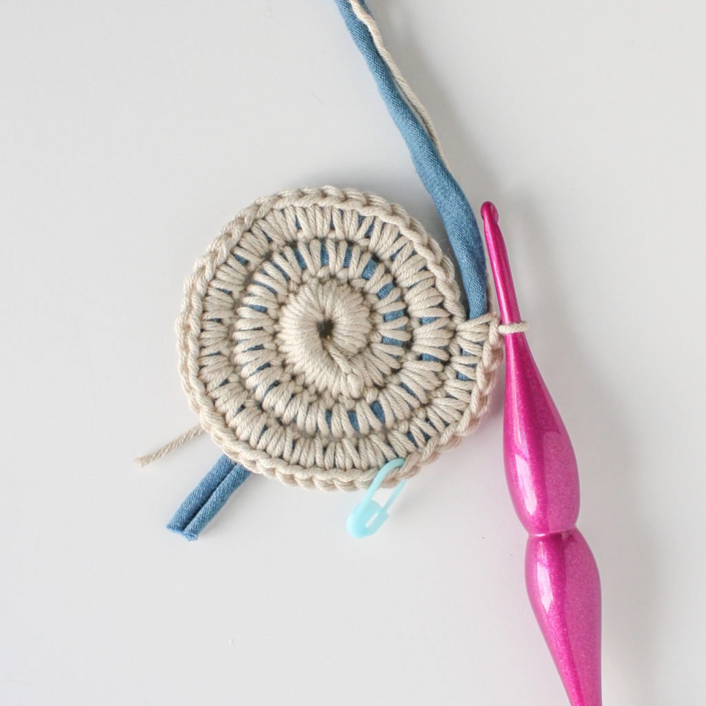 Use this free crochet pattern and photo tutorial to epicycle old material into usable baskets.