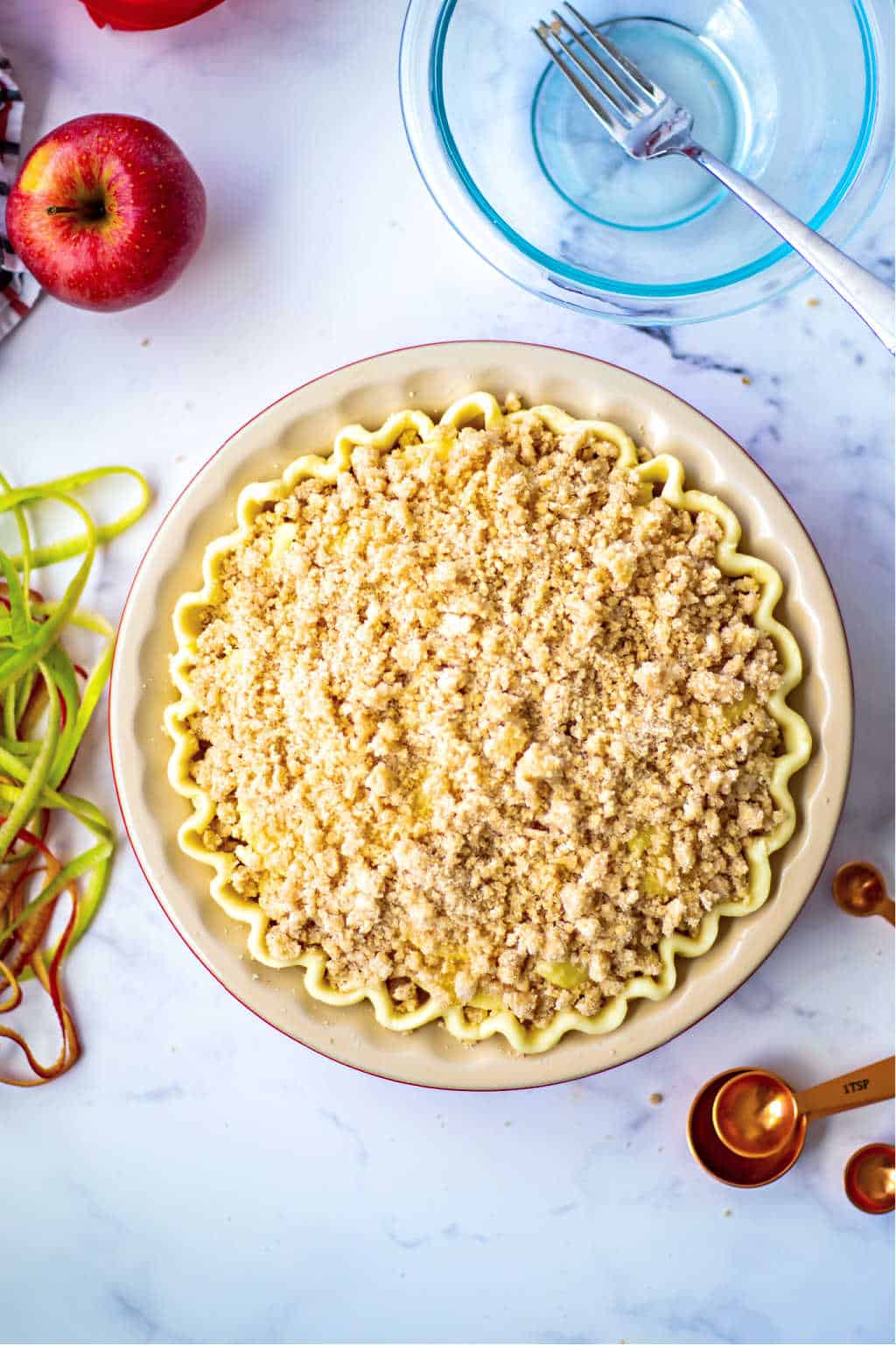 apple pie with a crumble on top ready for the oven