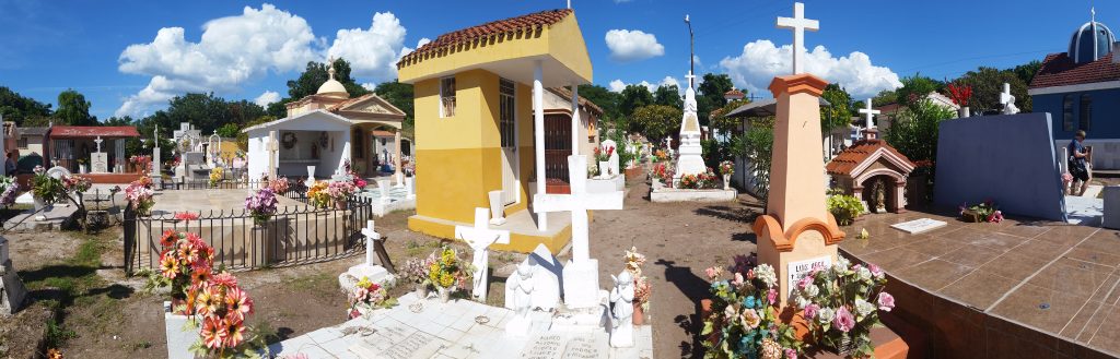 Mexican cemetery with brightly painted small mausoleums