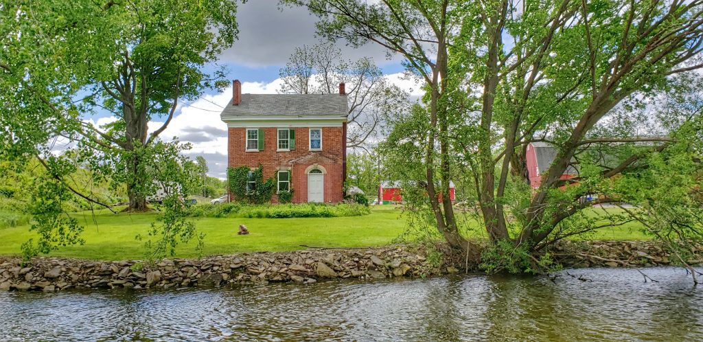 New England style brick farmhouse at the Erie Canal