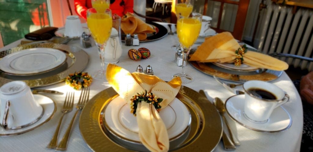 Table set with gold chargers and fancy table linens make you feel like a Vanderbilt