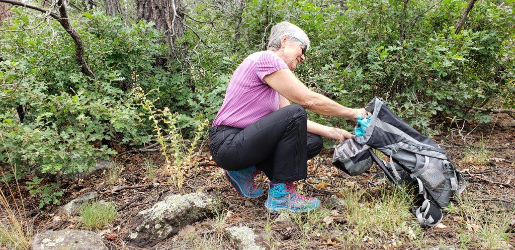 Unstoppable Stacey puts away her rain jacket after the rain passes. She's wearing her favorite Camino shirt - a Kuhl T-shirt made of cotton blendfabric.