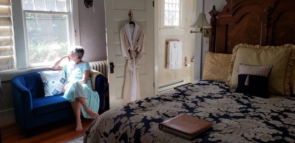 Travel blogger Unstoppable Stacey contemplates life as a Vanderbilt while looking out the bedroom window at Cumberland Falls bed and Breakfast.