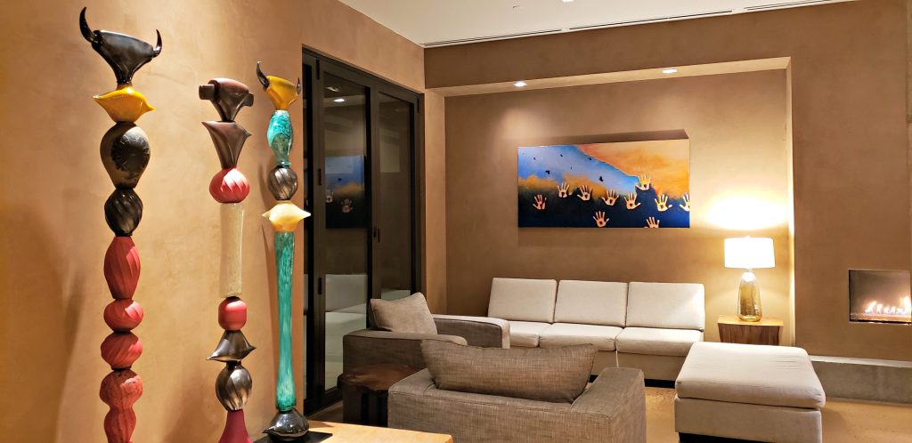 Hotel lobby with white sofa and modern native art sculptures