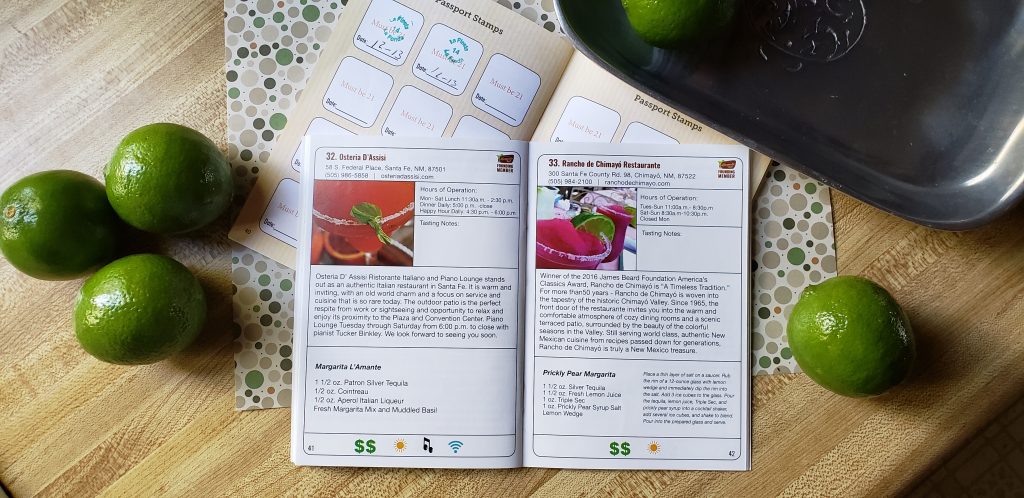 Santa fe Margarita Trail Passport lies open to two pages, one about the trail marg for Rancho de Chimayo