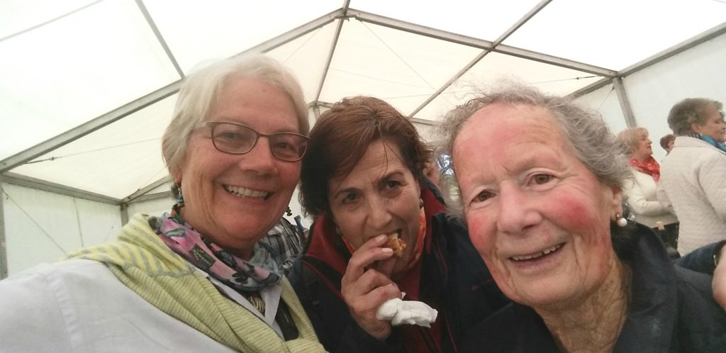 Arizona travel writer stacey Wittig hugs new Spanish friends - a woman her age and an older, shorter Asturian woman at this spiritual place on Camino Primitvo