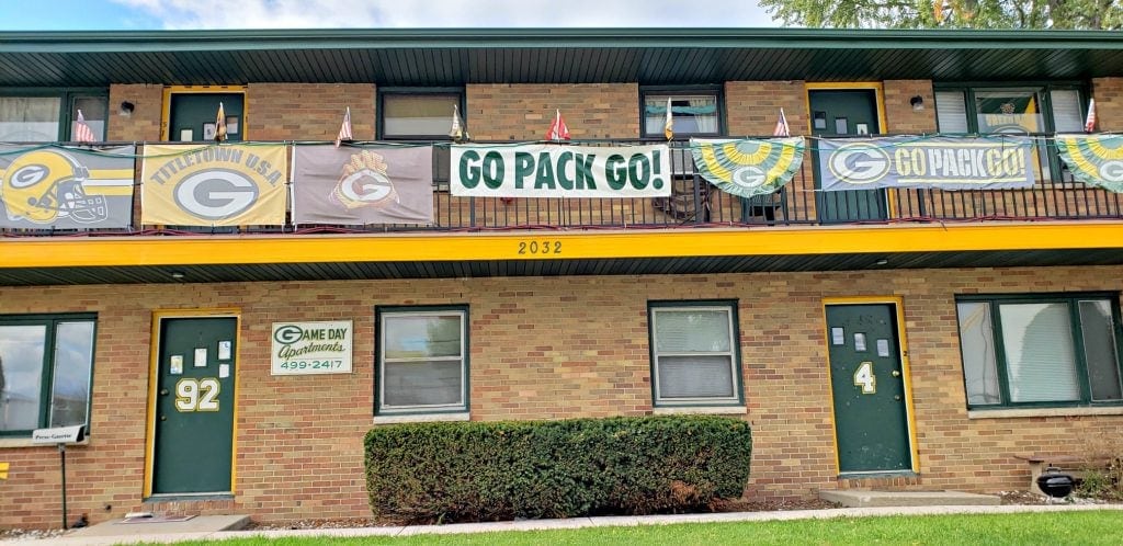 Green Bay Packer fans show enthusiasm with banners hanging in the front of their homes