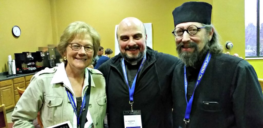 UNSTOPPABLE Stacey stands with two men with conference name tags around their necks - Tall man on right is Fr moses from Holy Resurrection monastery