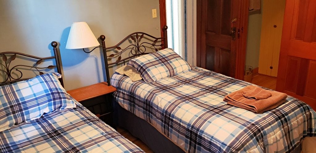 twin beds with night stand and lamp between