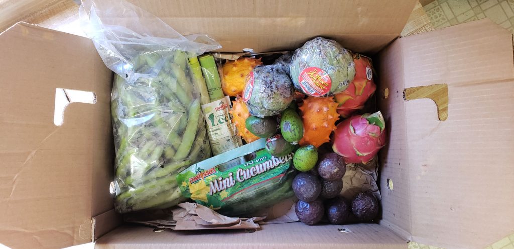 looking down into a freshly opened crate of melissa's Produce delivered to my door brimming with fresh produce