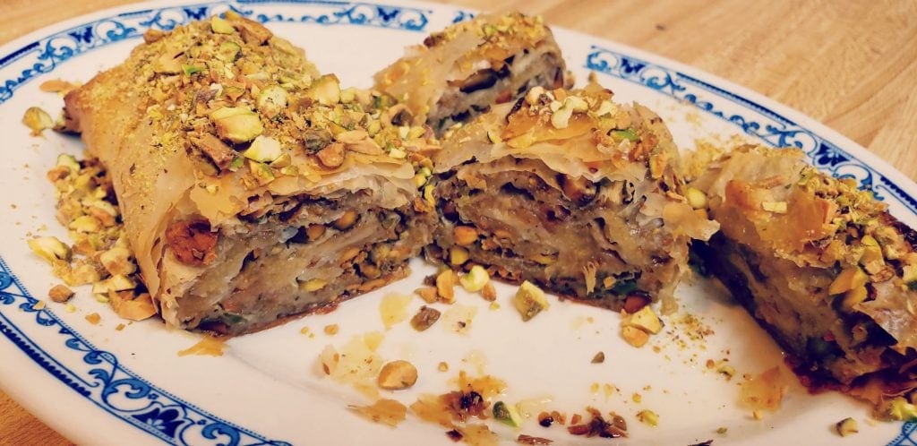 feijoa strudel on plate cut in three pieces - pistachios sprinkled around