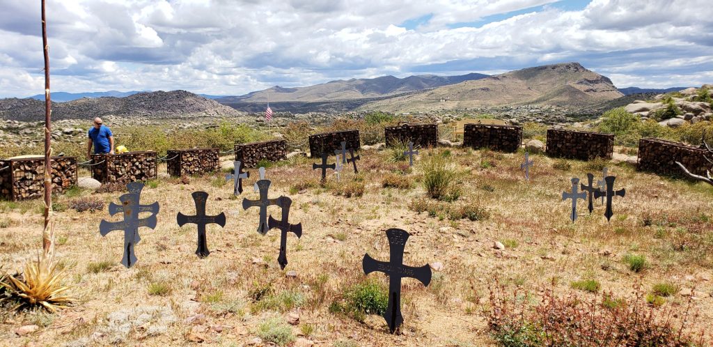 iron crosses in the dry desert box canyon with mountains on horizon