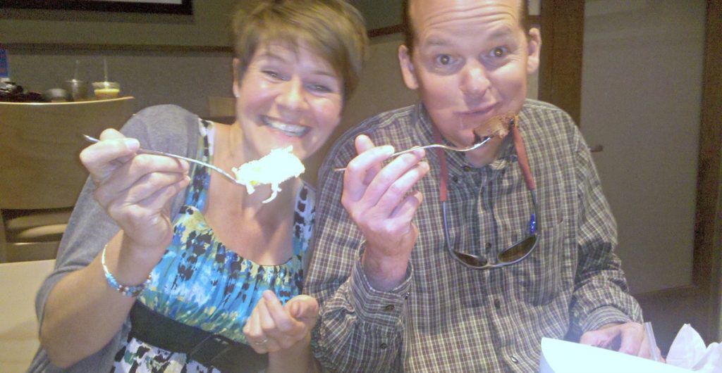 Two tasters smile as they sample Wildflower Bread Company wares