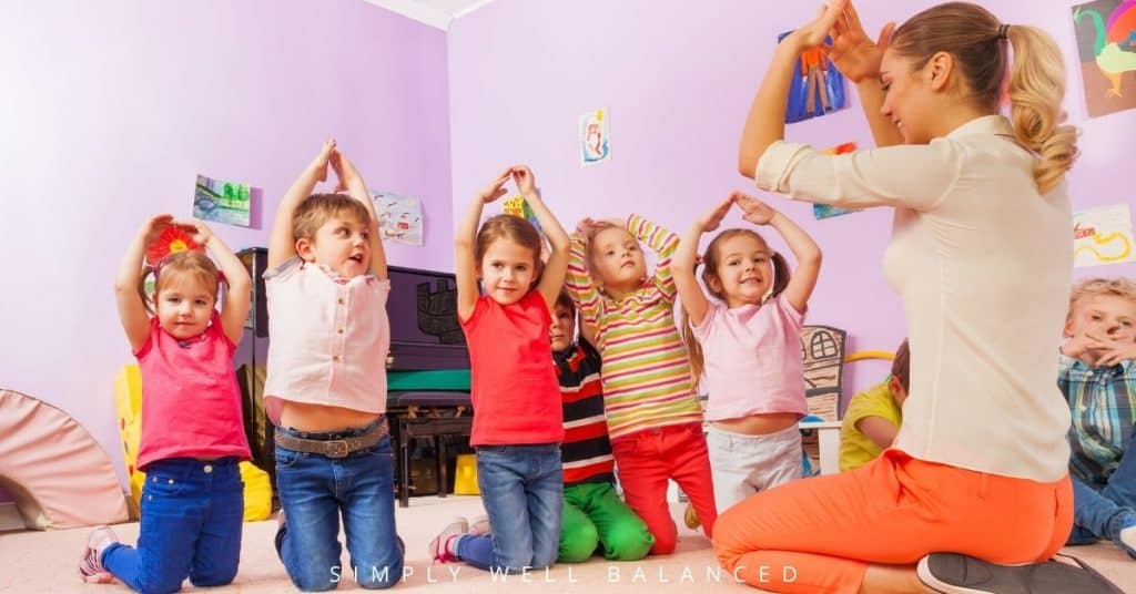 Teacher leading a group of kids playing Simon Says