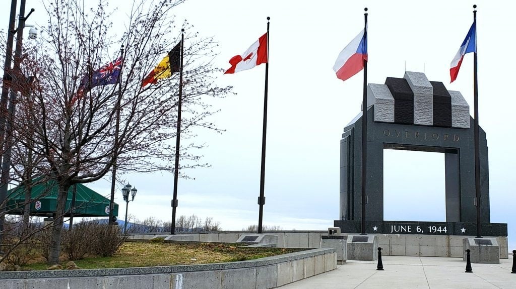 flags on tall flag poles surround the Overlord triumphal arch