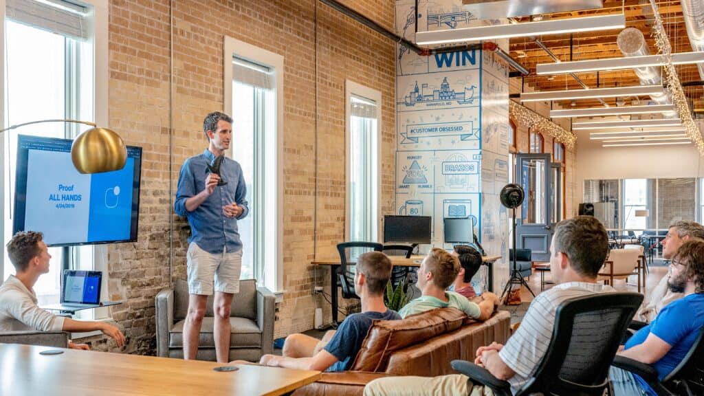 Product Manager presenting to the team. Group of people learning how to become a Product Manager from a professional PM.