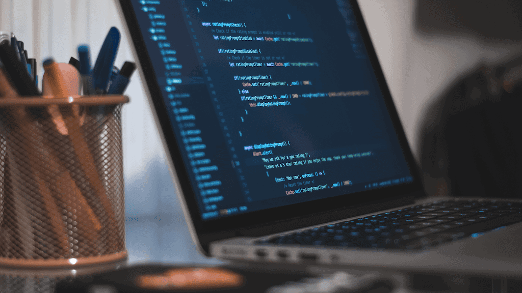 Software Engineer's Laptop with Code editor on the screen. Software Engineer's Laptop with Code editor on the screen.
