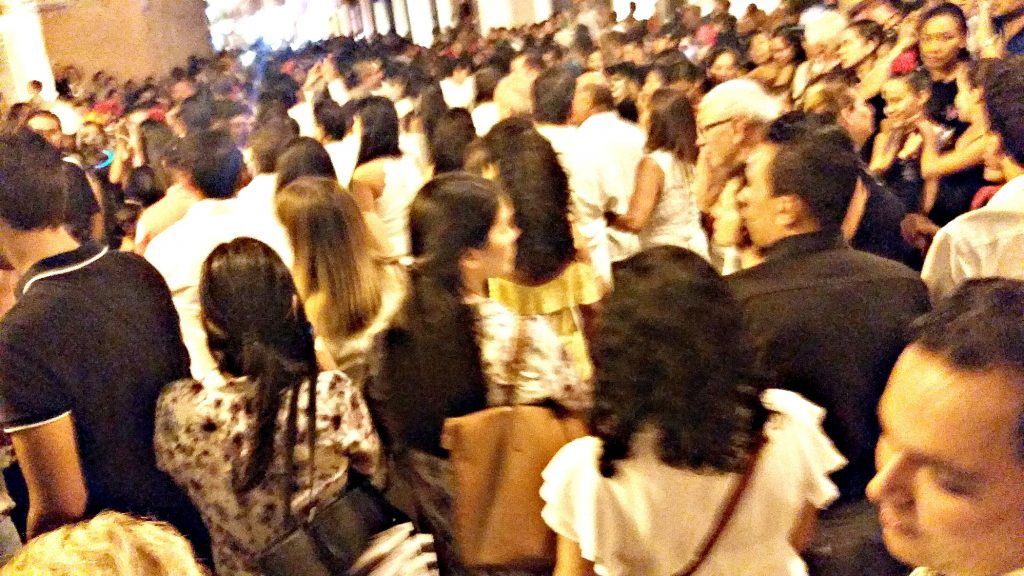 Street packed with people walking in the same direction