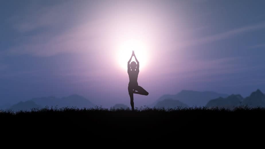 A girl in a yoga pose in a sunsnet