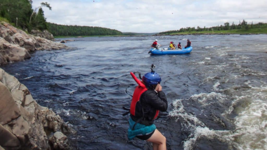 Brooke plugging her nose while jumping into the Exploits River.