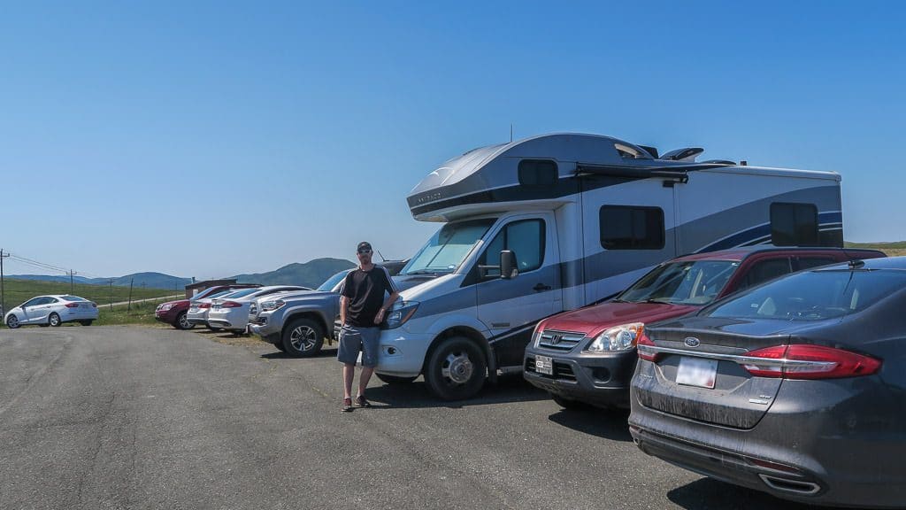 Buddy standing next to the RV he reverse parked at a trailhead in Newfoundland and fit perfectly.