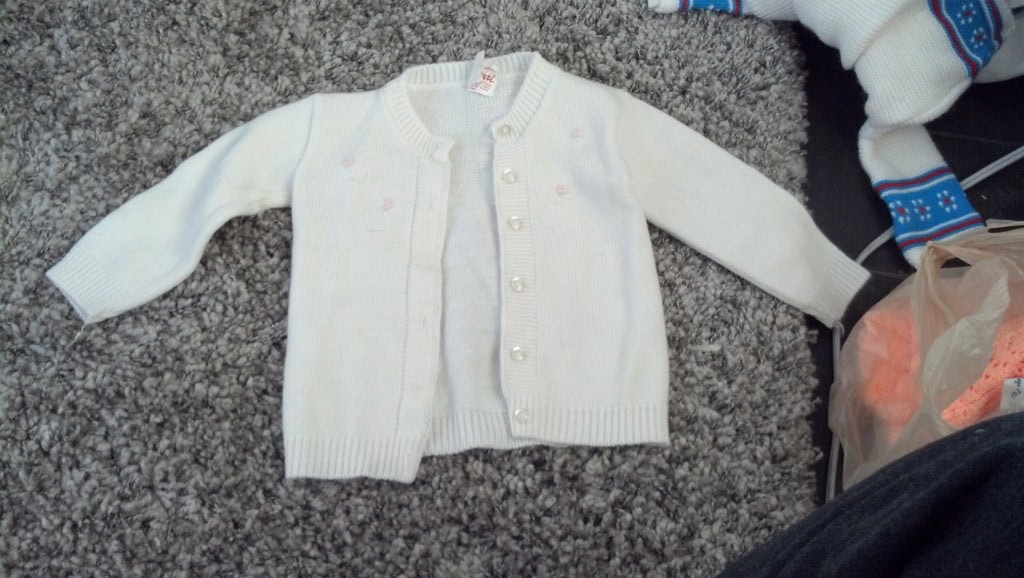 Becca gave me some of her baby cloths! The are freaking adorable! This one is my very favorite! These blonged to Becca when she was a baby, since they are having a boy she is letting me use the her little girl cloths, this sweater totally looks like something a 'Nora' would wear, huh? :) That is the name of the day!
