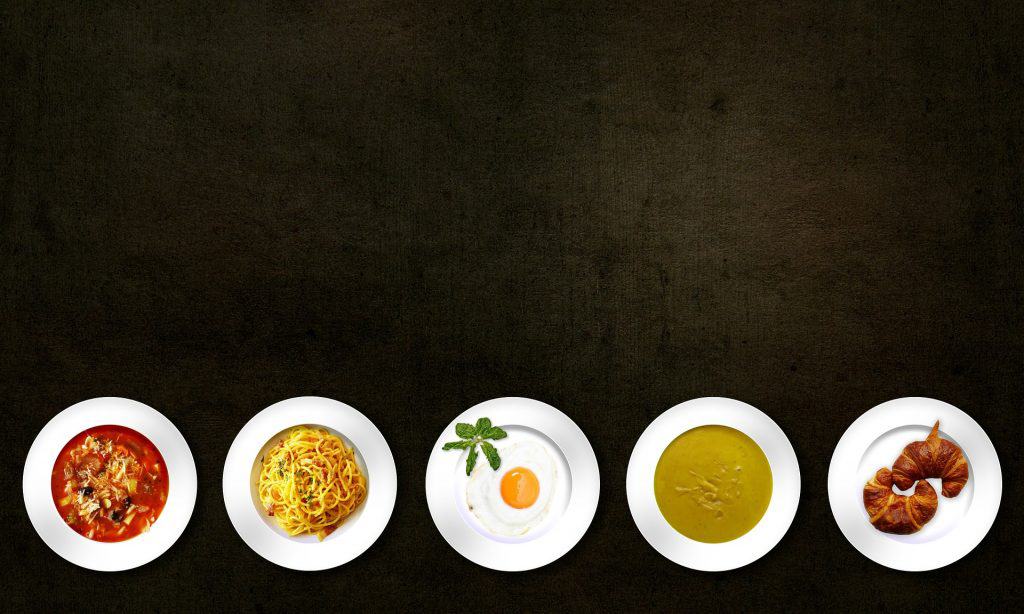 image of artfully arranged food servings on a black table