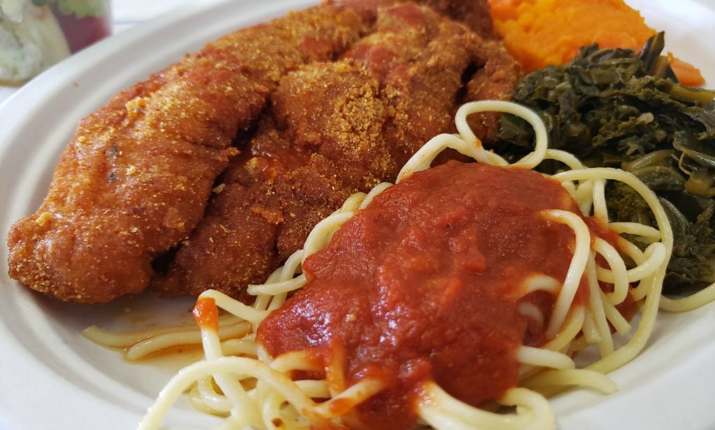 close up of plate with frie catfish, spaghetti with red sauce and greens and sweet potatoes (3 sides!)