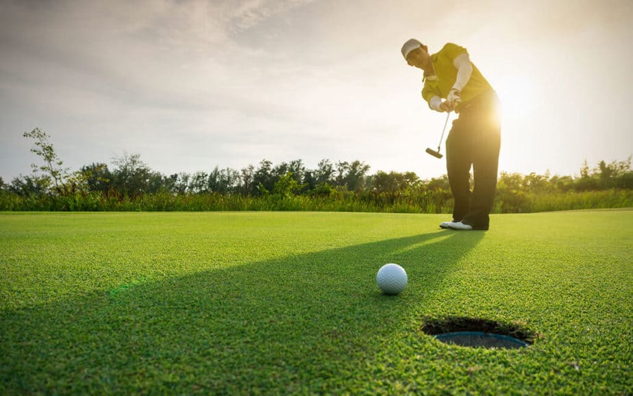 A young golfer is playing golf successfully