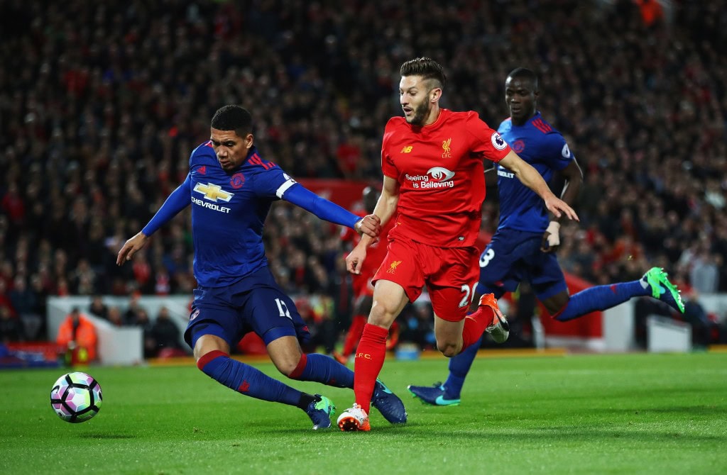 LIVERPOOL, ENGLAND - OCTOBER 17: Adam Lallana of Liverpool is challenged by Chris Smalling of Manchester United during the Premier League match between Liverpool and Manchester United at Anfield on October 17, 2016 in Liverpool, England. (Photo by Clive Brunskill/Getty Images)