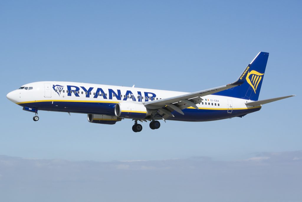 white and navy Ryanair Boeing 737 in air with landing gear down at Leeds Bradford Airport