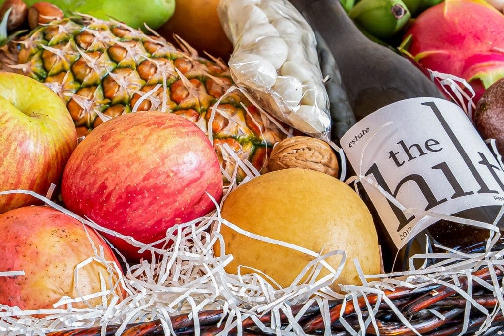 close up of fruit and bottle of 2017 The Hilt Estate Pinot Noir in Valentine's gift basket