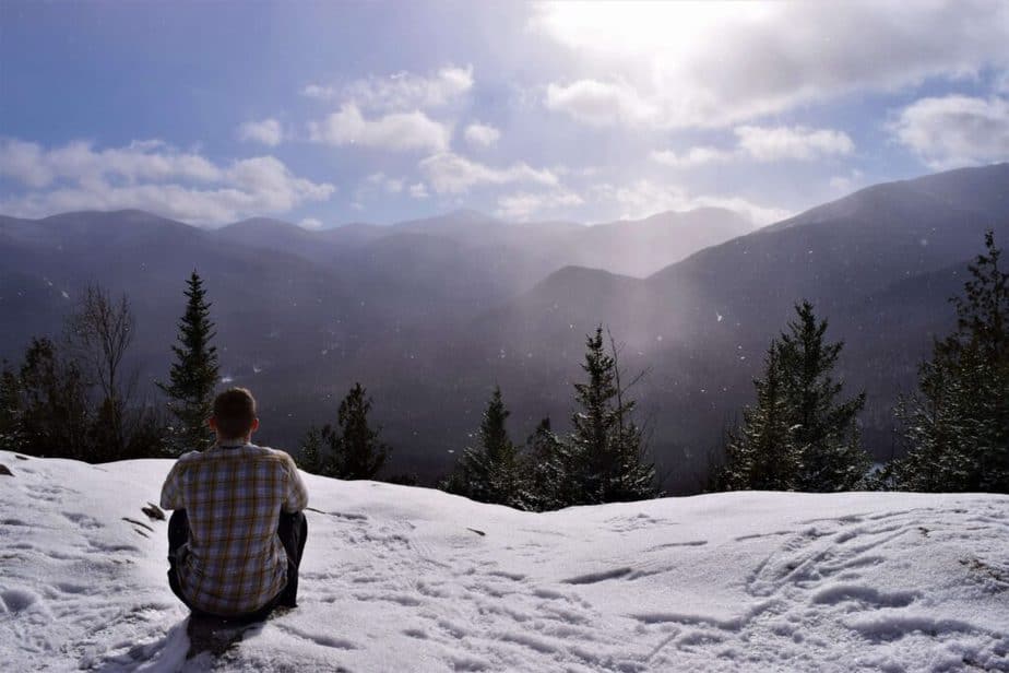 A man is soaking up the sun, at the snow