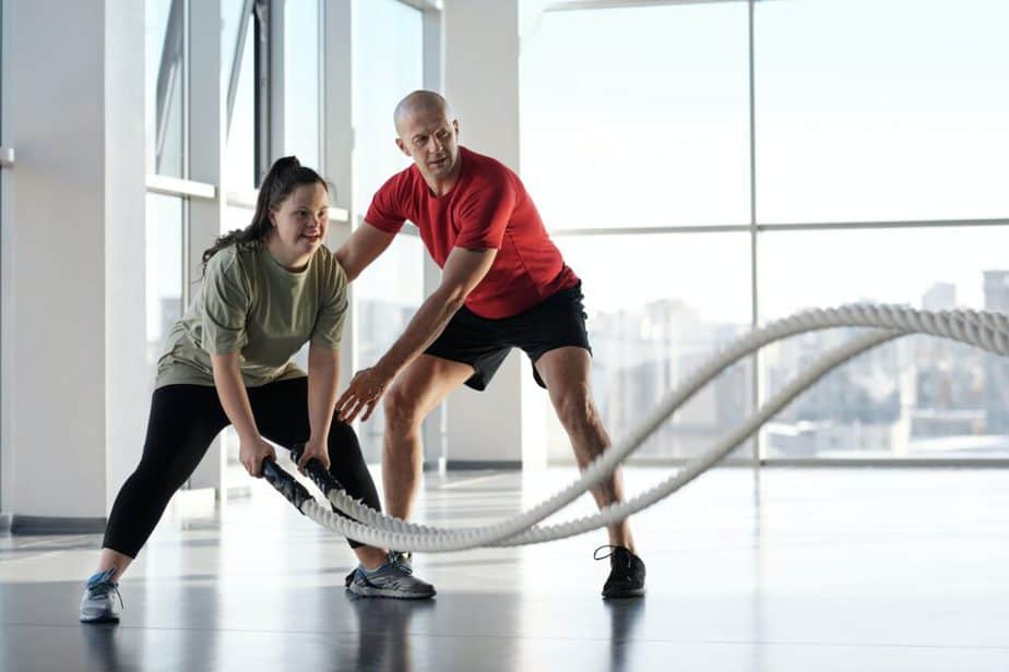 A girl has a training with battle ropes