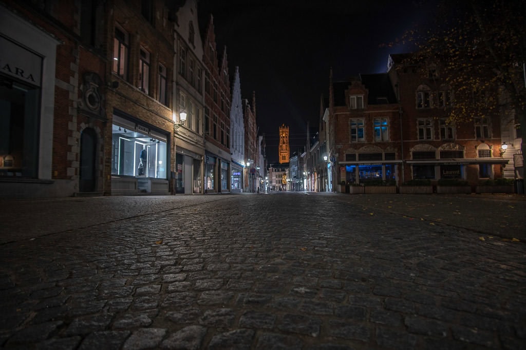 sidewalk and city at night during a perfect weekend in bruges belgium