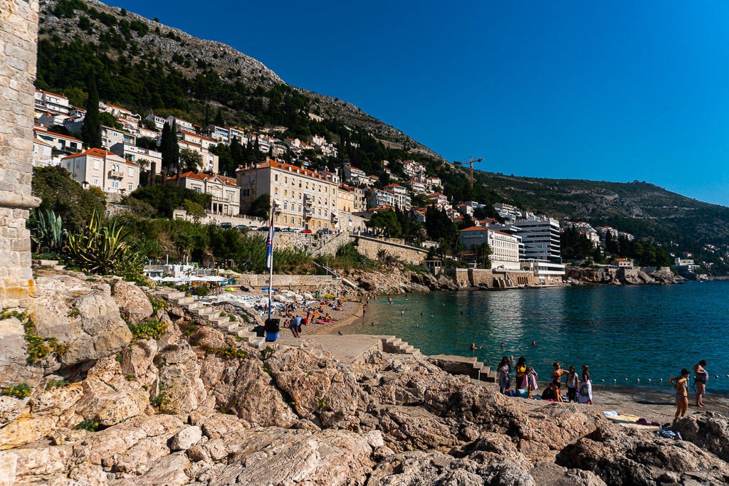 Tourists sunbathing and swimming at Banje Beach