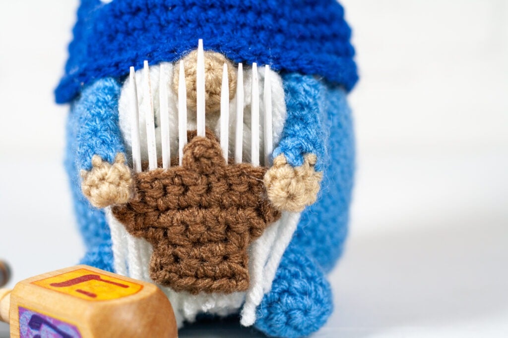 Celebrate the holidays with this crochet Hanukkah gnome. Free crochet pattern for a fun holiday decoration with a video tutorials.