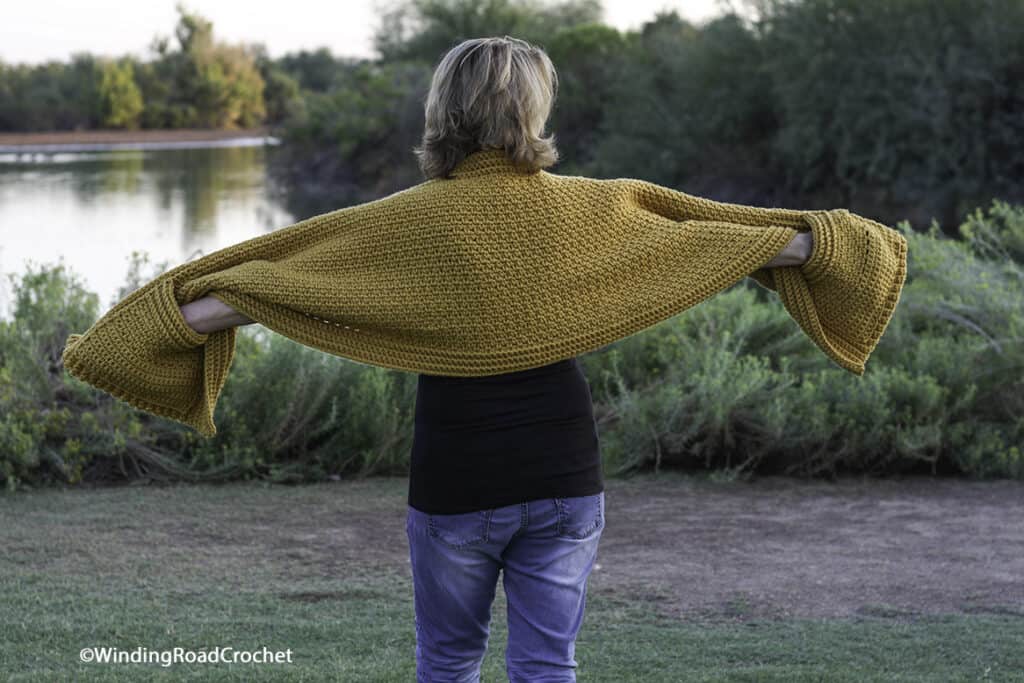 Crochet a super easy pocket shawl that will keep you warm and cozy. Free crochet pattern and easy to follow video tutorial.