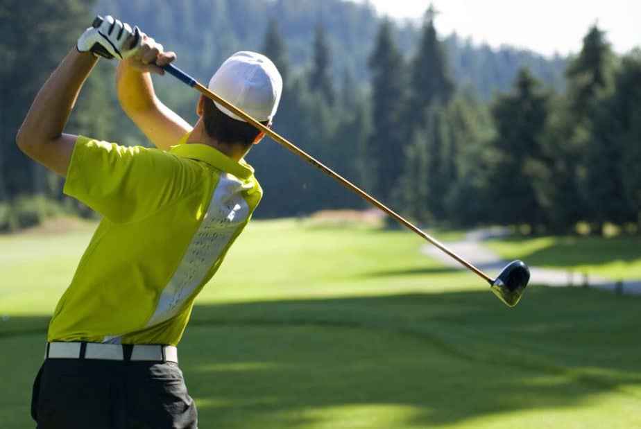 A young man is playing golf