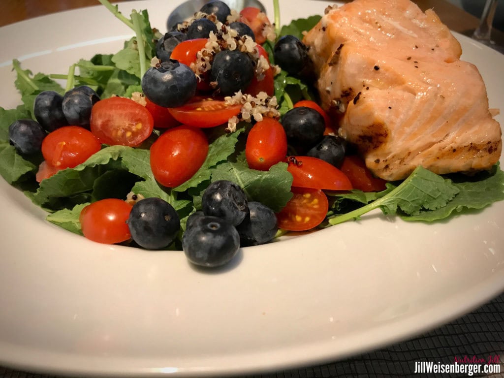 healthy salad of greens, berries and salmon