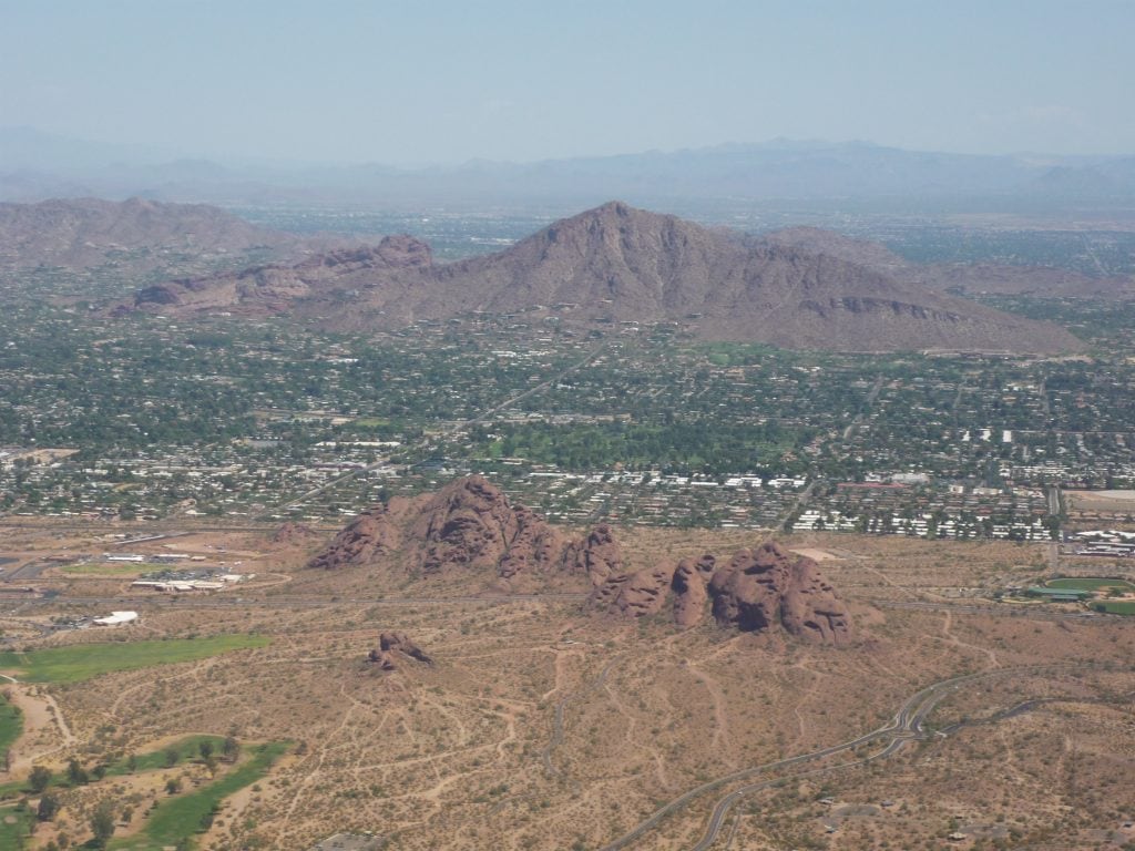 camelback mountain is dark red in coloe an is in the shape of a sleeping camel
