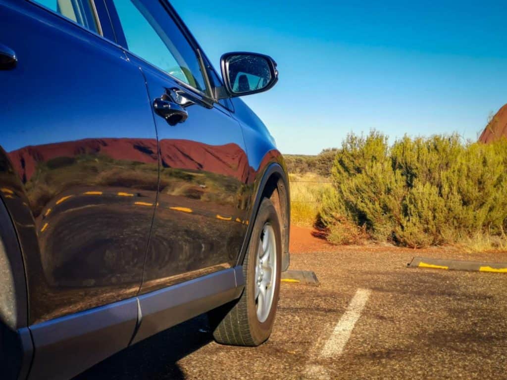 Reflection of Uluru/Ayers rock on car