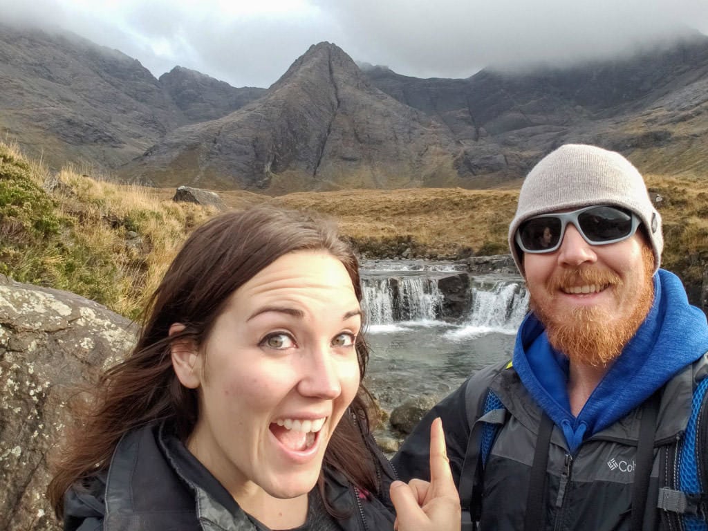 Brooke and Buddy at one of the small waterfalls in the Fairy Pools area of the Isle of Skye, once of the many things to do in the Isle of Skye in Scotland