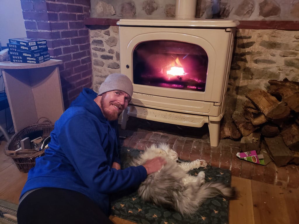 In an old house in France, snuggling a cat we were pet sitting through trustedhousesitters while lounging next to a fire