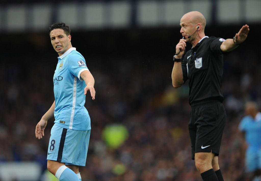 Manchester City's Samir Nasri (L) argues with referee Anthony Taylor (R) earning himself a yellow card during the English Premier League soccer match between Everton and Manchester City at Goodison Park, Liverpool, Britain, 23 August 2015. EPA/PETER POWELL