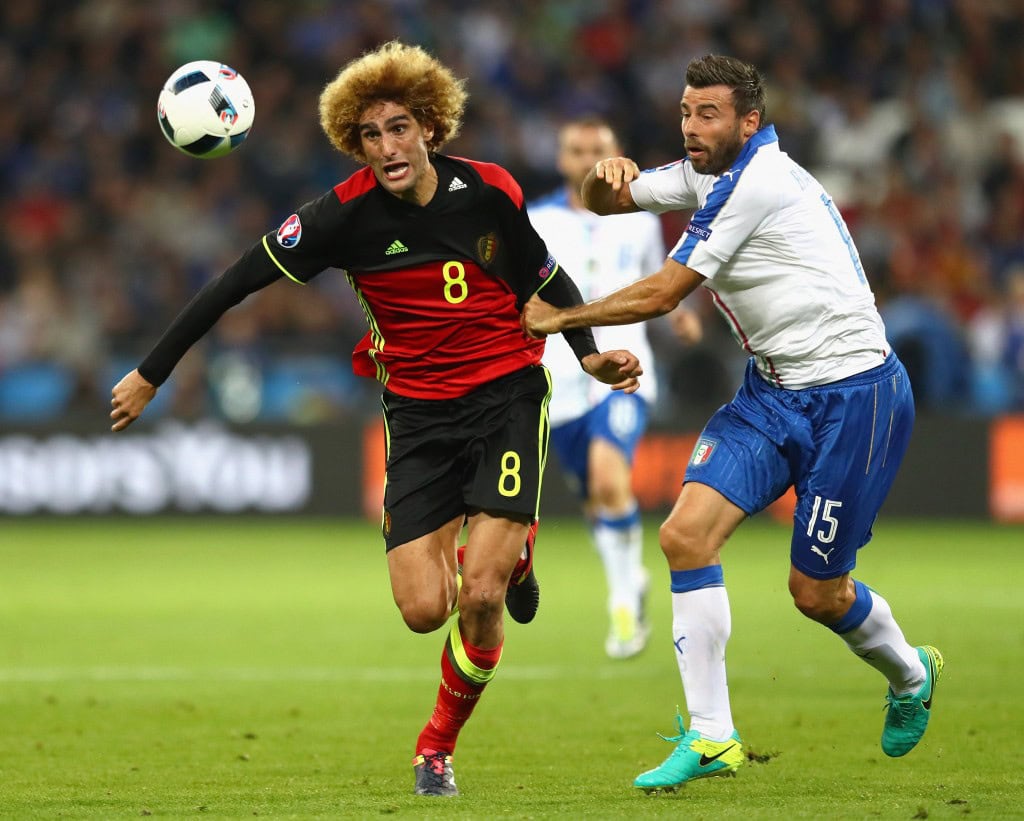 LYON, FRANCE - JUNE 13: Marouane Fellaini of Belgium and Andrea Barzagli of Italy battle for the ball during the UEFA EURO 2016 Group E match between Belgium and Italy at Stade des Lumieres on June 13, 2016 in Lyon, France. (Photo by Julian Finney/Getty Images)