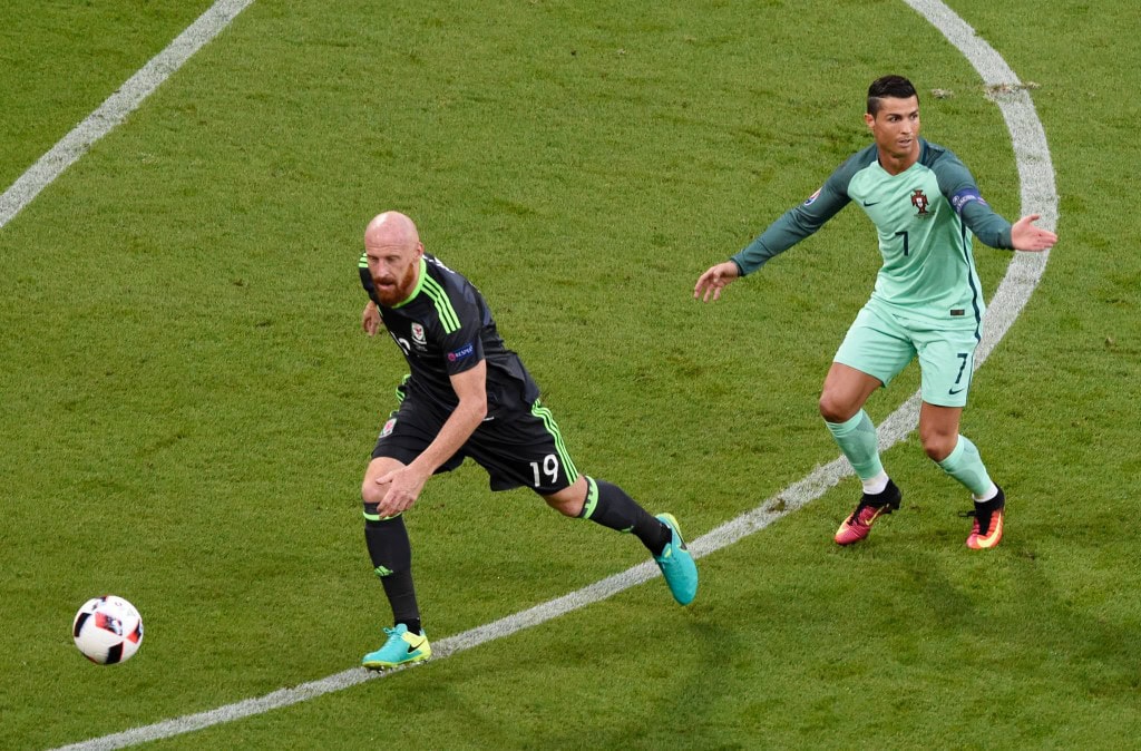 (LtoR) Wales' defender James Collins and Portugal's forward Cristiano Ronaldo vie for the ball during the Euro 2016 semi-final football match between Portugal and Wales at the Parc Olympique Lyonnais stadium in Décines-Charpieu, near Lyon, on July 6, 2016. / AFP / JEAN-PHILIPPE KSIAZEK (Photo credit should read JEAN-PHILIPPE KSIAZEK/AFP/Getty Images)