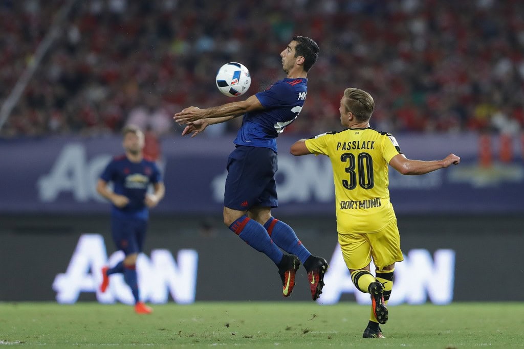 SHANGHAI, CHINA - JULY 22: Henrikh Mkhitaryan (L) of Manchester United competes for the ball with Felix Passlack of Borussia Dortmund during the International Champions Cup match between Manchester United and Borussia Dortmund at Shanghai Stadium on July 22, 2016 in Shanghai, China. (Photo by Lintao Zhang/Getty Images)