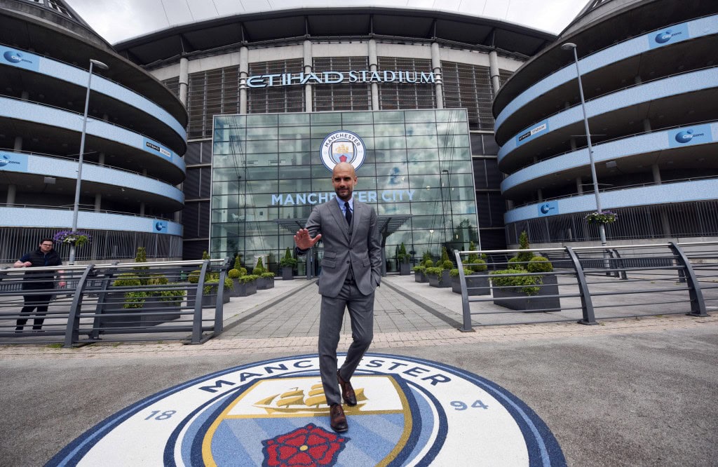 Manchester City's Spanish football coach Pep Guardiola poses for photographs outside the Etihad Stadium in Manchester, northern England, on July 8, 2016. Pep Guardiola has warned his Manchester City players that they have to prove themselves all over again following his arrival at the club. / AFP / OLI SCARFF / RESTRICTED TO EDITORIAL USE. NO USE WITH UNAUTHORIZED AUDIO, VIDEO, DATA, FIXTURE LISTS, CLUB/LEAGUE LOGOS OR "LIVE" SERVICES. ONLINE IN-MATCH USE LIMITED TO 45 IMAGES, NO VIDEO EMULATION. NO USE IN BETTING, GAMES OR SINGLE CLUB/LEAGUE/PLAYER PUBLICATIONS. (Photo credit should read OLI SCARFF/AFP/Getty Images)