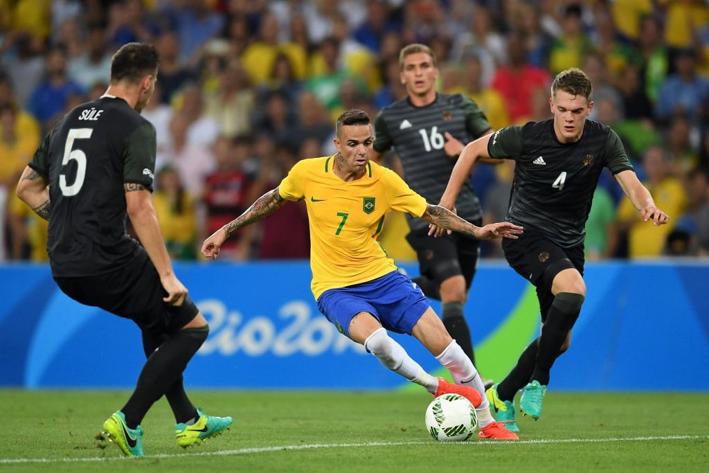 RIO DE JANEIRO, BRAZIL - AUGUST 20: Luan of Brazil holds off Matthias Lukas Ginter of Germany during the Men's Football Final between Brazil and Germany at the Maracana Stadium on Day 15 of the Rio 2016 Olympic Games on August 20, 2016 in Rio de Janeiro, Brazil. (Photo by Laurence Griffiths/Getty Images)